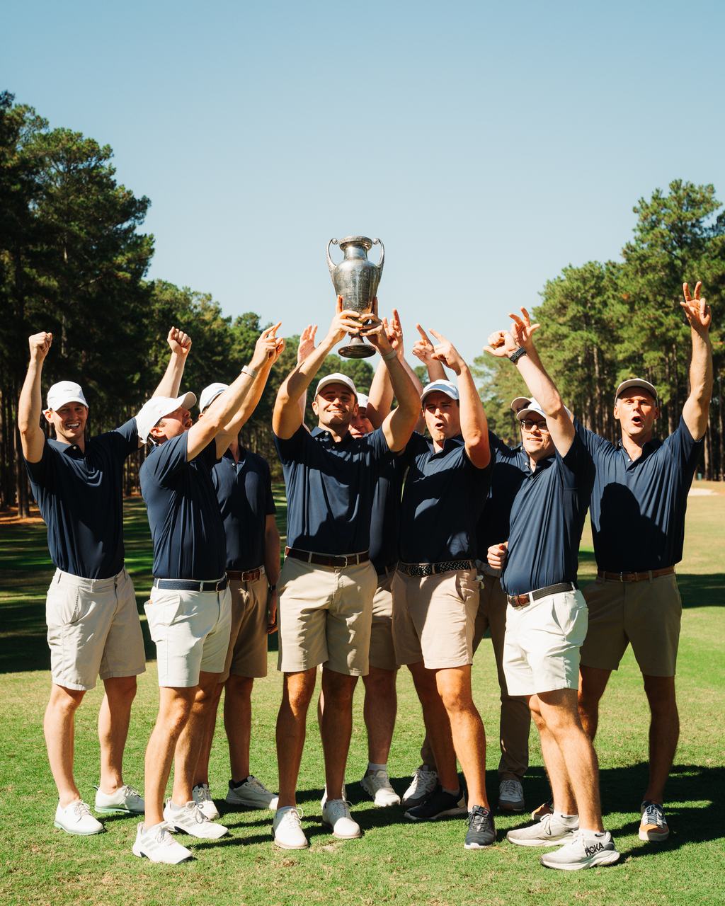Team Moquist lifts the antique trophy at Pinewild Country Club